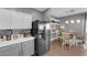 Eat-in kitchen featuring stainless steel appliances, stone countertops, and gray and white cabinetry with shelving at 855 N Stephanie St # 2121, Henderson, NV 89014