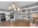 Eat-in kitchen featuring stainless steel appliances, stone countertops, gray and white cabinetry, and stylish lighting at 855 N Stephanie St # 2121, Henderson, NV 89014