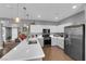 Bright kitchen featuring white cabinetry, stainless steel appliances, and an open layout with views into the living area at 855 N Stephanie St # 2121, Henderson, NV 89014