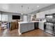 Modern kitchen featuring white cabinetry, a center island with seating, stainless steel appliances, and updated finishes at 855 N Stephanie St # 2121, Henderson, NV 89014