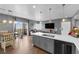 Open-concept kitchen with stainless appliances, stone countertops, island sink, and view to the living room at 855 N Stephanie St # 2121, Henderson, NV 89014