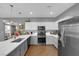 Modern kitchen featuring stainless steel appliances, stone countertops, and stylish gray and white cabinetry at 855 N Stephanie St # 2121, Henderson, NV 89014