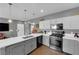 Bright kitchen showcasing stainless steel appliances, stone countertops, and trendy gray and white cabinetry at 855 N Stephanie St # 2121, Henderson, NV 89014