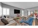 Cozy living room with comfortable seating, a large TV, and a view of the entryway and adjacent room at 855 N Stephanie St # 2121, Henderson, NV 89014