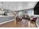Open-concept living and kitchen area with modern finishes, hardwood floors, stylish furniture, and natural light at 855 N Stephanie St # 2121, Henderson, NV 89014