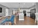Open-concept living space with a view of the kitchen and dining area, featuring modern decor and hardwood floors at 855 N Stephanie St # 2121, Henderson, NV 89014