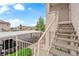 Close-up view of stairs leading to an apartment unit in the complex, featuring a covered parking area nearby at 855 N Stephanie St # 2121, Henderson, NV 89014