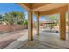 Covered back patio featuring concrete flooring and a view of the gazebo and landscaped backyard at 9092 National Park Dr, Las Vegas, NV 89178