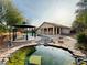 Beautifully landscaped backyard with a gazebo, pond, and walking path at 9092 National Park Dr, Las Vegas, NV 89178