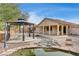 Backyard featuring gazebo with table and chairs, pond, bridge, and rock landscaping at 9092 National Park Dr, Las Vegas, NV 89178