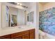 Bathroom includes under sink storage and a shower behind a cute fish curtain at 9092 National Park Dr, Las Vegas, NV 89178
