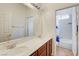 Well-lit bathroom with dual sinks, a large mirror, and a separate toilet area at 9092 National Park Dr, Las Vegas, NV 89178