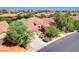 Well-maintained single-story home with a three-car garage, mature trees, and manicured landscaping at 9092 National Park Dr, Las Vegas, NV 89178