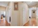 Hallway with hardwood floors, neutral walls, and white trim offers access to other rooms at 9092 National Park Dr, Las Vegas, NV 89178