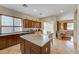 Well-lit kitchen featuring an island, dark wood cabinetry, and seamless flow into adjacent living spaces at 9092 National Park Dr, Las Vegas, NV 89178