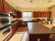 Well-equipped kitchen featuring wood cabinets, stainless appliances, and an island with seating at 9092 National Park Dr, Las Vegas, NV 89178