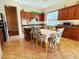 Functional kitchen with stainless double oven, island, wood cabinets and breakfast table seating at 9092 National Park Dr, Las Vegas, NV 89178