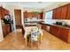 A functional kitchen space featuring a breakfast table, dark wood cabinets and stainless appliances at 9092 National Park Dr, Las Vegas, NV 89178