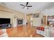 Spacious living room featuring hardwood floors, fireplace, and open access to dining and kitchen areas at 9092 National Park Dr, Las Vegas, NV 89178