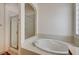 Main bathroom featuring walk-in shower and soaking tub for relaxation at 9092 National Park Dr, Las Vegas, NV 89178