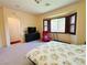Main bedroom featuring bay window, closet, carpet floors, and access to an adjacent room at 9092 National Park Dr, Las Vegas, NV 89178