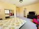 Spacious main bedroom with sitting area, TV, mirrored closet, and carpet flooring at 9092 National Park Dr, Las Vegas, NV 89178