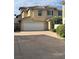 Two story home featuring an attached two car garage, desert landscaping, and a tile roof at 9329 Iceland Spar Ct, Las Vegas, NV 89148