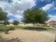Neighborhood green space with mature trees, landscaped area, and parking at 9329 Iceland Spar Ct, Las Vegas, NV 89148