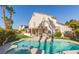 Expansive backyard with sparkling pool, lush landscaping, and covered patio at 9485 Supernova Ct, Las Vegas, NV 89123
