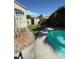 Artificial grass and patio area offer low-maintenance backyard and direct access to swimming pool at 9485 Supernova Ct, Las Vegas, NV 89123