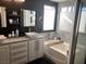 Modern bathroom features dual sinks, a tub, and contemporary finishes at 9485 Supernova Ct, Las Vegas, NV 89123