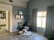 This cozy bedroom provides a comfortable sitting area and natural light at 9485 Supernova Ct, Las Vegas, NV 89123