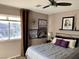 Comfortable bedroom with large window, stylish decor and neutral tones at 9485 Supernova Ct, Las Vegas, NV 89123