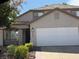 Attractive two-story home featuring a well-manicured front yard, a spacious garage, and a welcoming entrance at 9485 Supernova Ct, Las Vegas, NV 89123