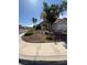 Beautifully landscaped front yard featuring a rock garden and mature tree, enhancing curb appeal at 9485 Supernova Ct, Las Vegas, NV 89123