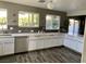 Well lit kitchen featuring quartz countertops, white cabinetry and stainless steel appliances at 9485 Supernova Ct, Las Vegas, NV 89123