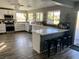 Bright kitchen featuring white cabinetry, modern appliances, quartz countertops and an island with stool seating at 9485 Supernova Ct, Las Vegas, NV 89123
