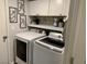 Convenient laundry room with modern washer and dryer, cabinet storage at 9485 Supernova Ct, Las Vegas, NV 89123