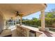 Covered outdoor bar area overlooking a pool and landscaped backyard at 9485 Supernova Ct, Las Vegas, NV 89123