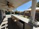 Covered patio featuring a bar with a mini refrigerator at 9485 Supernova Ct, Las Vegas, NV 89123