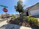Charming neighborhood featuring well-maintained homes, lush landscaping, and a prominent stop sign at 9485 Supernova Ct, Las Vegas, NV 89123