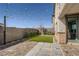 Low maintenance backyard featuring artificial turf, patio pavers, and ambient string lights for a welcoming outdoor space at 9576 Archer Peak Ct, Las Vegas, NV 89143