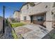 Inviting backyard with artificial turf, pavers, and charming string lights for outdoor relaxation and entertainment at 9576 Archer Peak Ct, Las Vegas, NV 89143