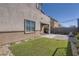 Well-maintained backyard with artificial turf, patio pavers, and string lights, perfect for outdoor activities and relaxation at 9576 Archer Peak Ct, Las Vegas, NV 89143