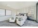 Spacious bedroom with accent chairs, neutral tones, and ample natural light creates an inviting and relaxing atmosphere at 9576 Archer Peak Ct, Las Vegas, NV 89143