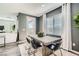Stylish dining area with modern furnishings and a view through the window to the outdoors at 9576 Archer Peak Ct, Las Vegas, NV 89143