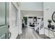 Inviting entryway with light grey wood floors, a staircase and a view into the modern living spaces at 9576 Archer Peak Ct, Las Vegas, NV 89143