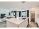 Open-concept kitchen and living space with a large kitchen island, sleek appliances, and plenty of counter space at 9576 Archer Peak Ct, Las Vegas, NV 89143