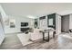 Bright living room with white sofa, modern decor and wood-style flooring throughout the home at 9576 Archer Peak Ct, Las Vegas, NV 89143