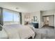 The primary bedroom boasts natural light, neutral colors, balcony access, and an ensuite bathroom at 9576 Archer Peak Ct, Las Vegas, NV 89143